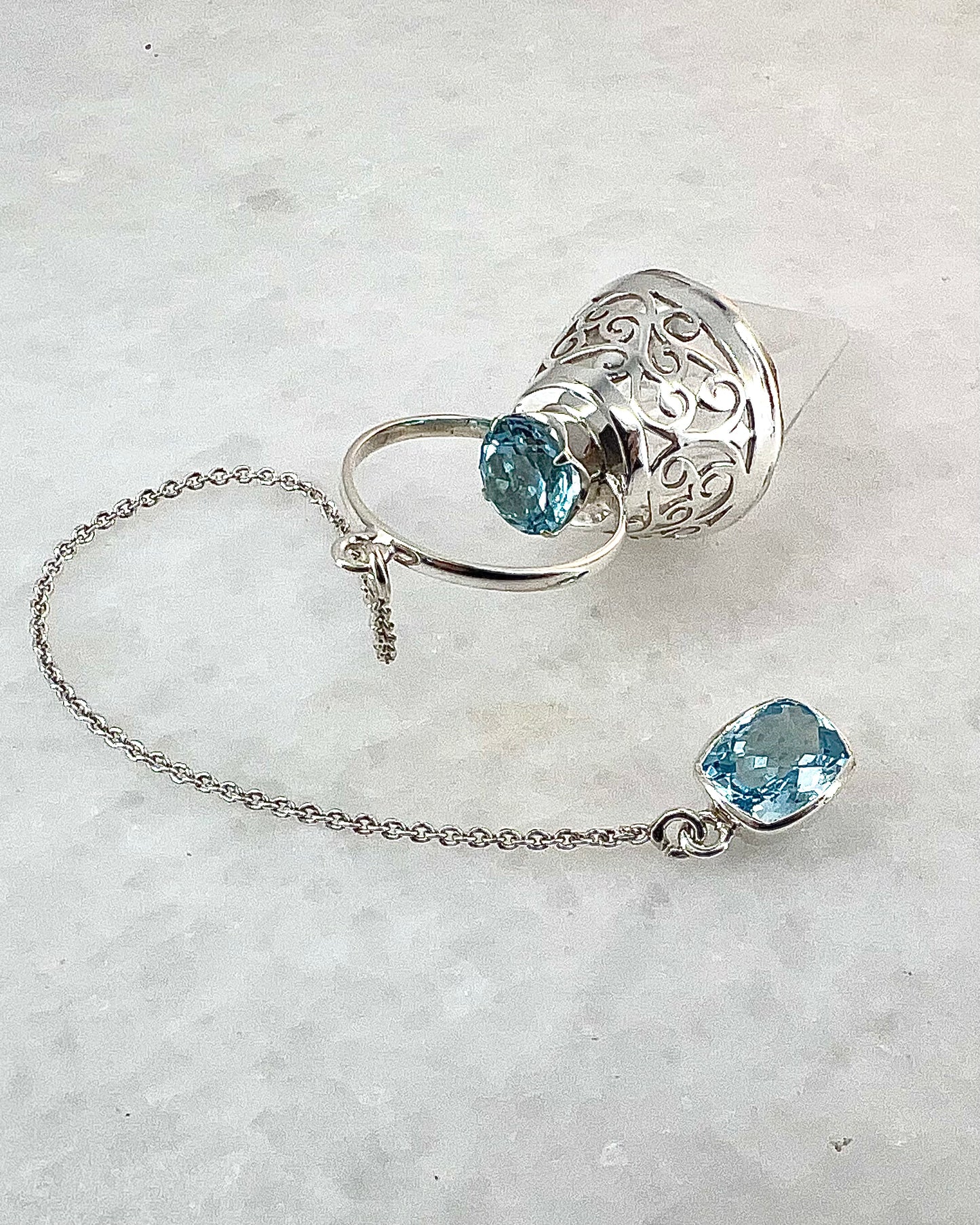 Vogel Cut Crystal Point with Facetted Blue Topazes in Fancy .925 Silver Setting with Cutwork Design as a Pendulum