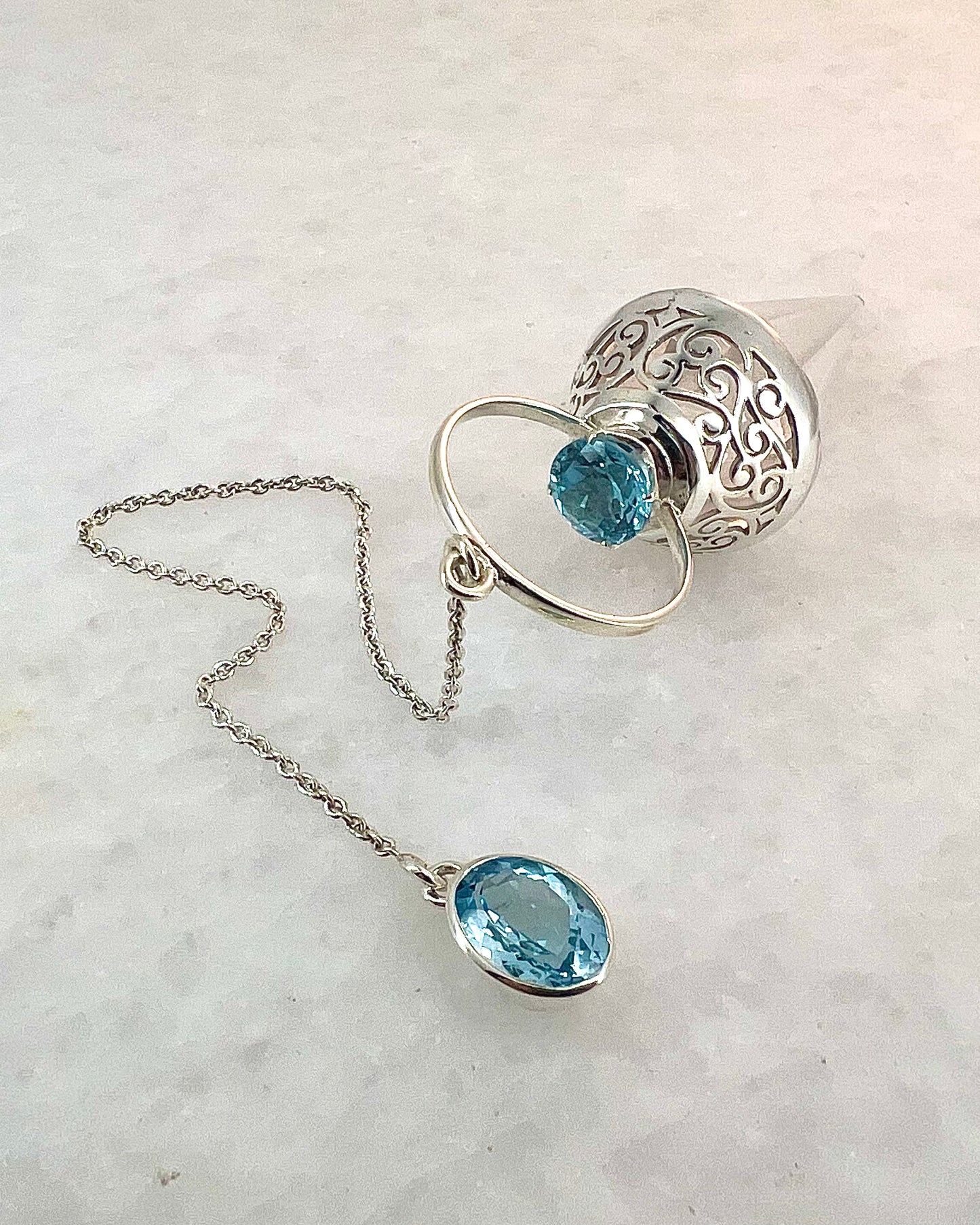 Vogel Cut Crystal Point with Facetted Blue Topazes in Fancy .925 Silver Setting with Cutwork Design as a Pendulum