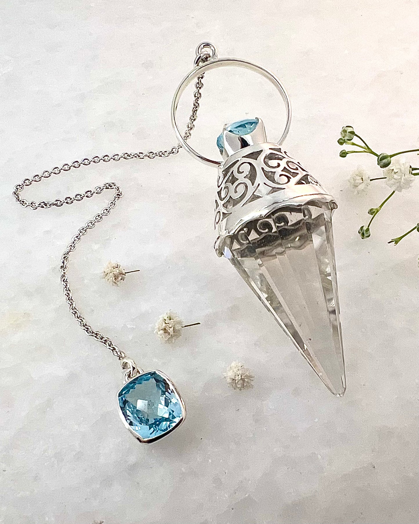 Vogel Cut Crystal Point with Facetted Blue Topazes in Fancy .925 Silver Setting with Cutwork Design as a Pendulum