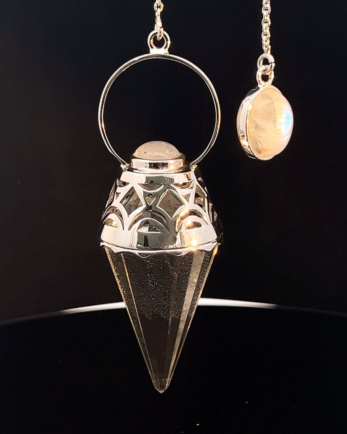 Vogel Cut Crystal Point w/ Rainbow Moonstone Cabachons in Fancy .925 Silver Setting w/ Cutwork Design as a Pendulum