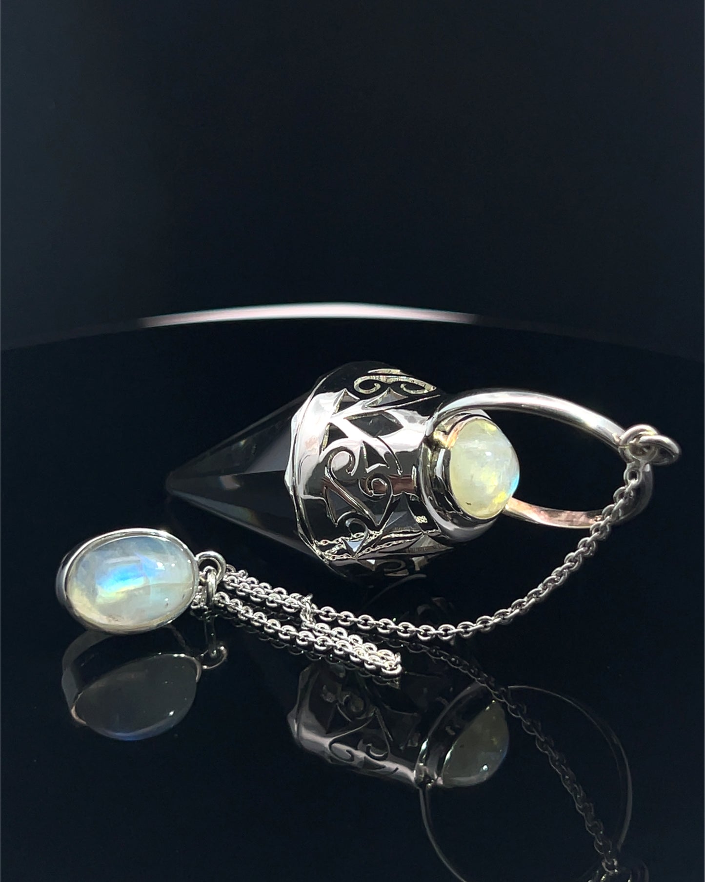 Vogel Cut Crystal Point w/ Rainbow Moonstone Cabachons in Fancy .925 Silver Setting w/ Cutwork Design as a Pendulum