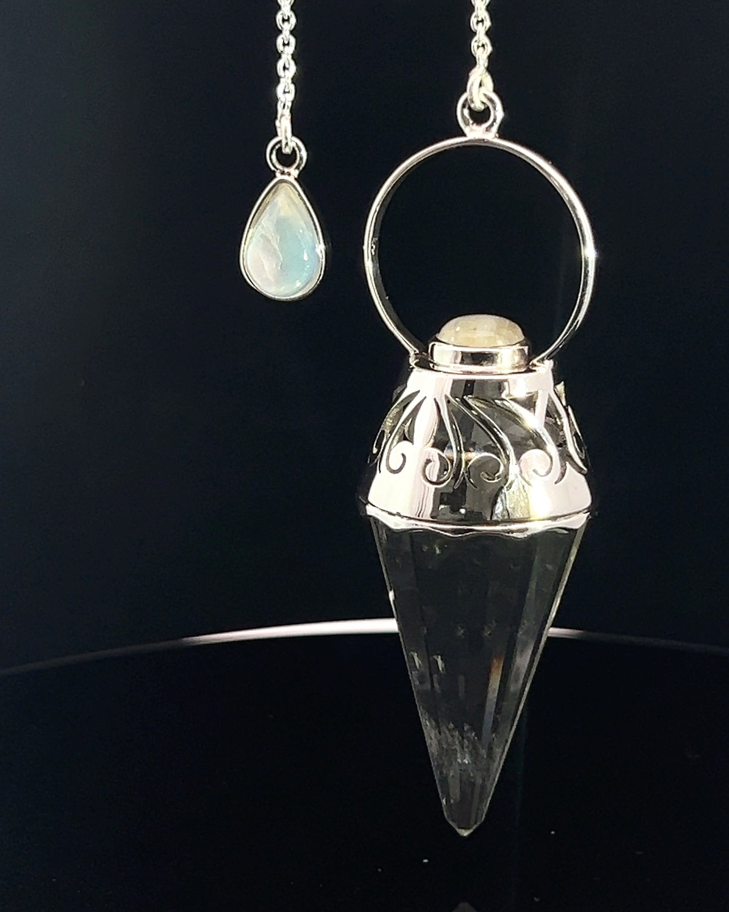 Vogel Cut Crystal Point w/ Rainbow Moonstone Cabachons in Fancy .925 Silver Setting w/ Cutwork Design as a Pendulum