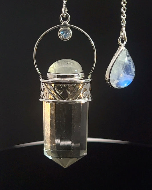 Straight 12 facet Crystal Point w/ Rainbow Moonstone Cabachons Accents and Finger Loop in Fancy .925 Silver Setting w/ Fancy Cutwork Design as a Pendulum