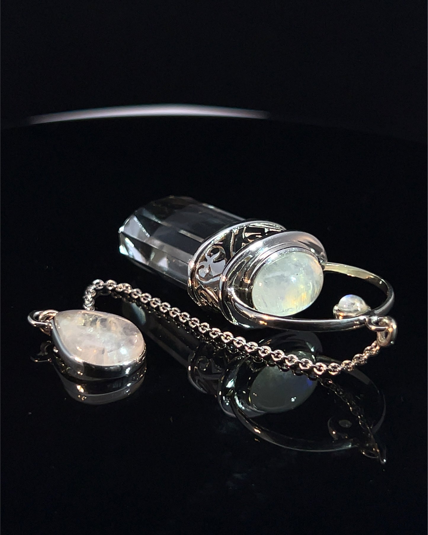 Straight 12 facet Crystal Point w/ Rainbow Moonstone Cabachons Accents and Finger Loop in Fancy .925 Silver Setting w/ Fancy Cutwork Design as a Pendulum