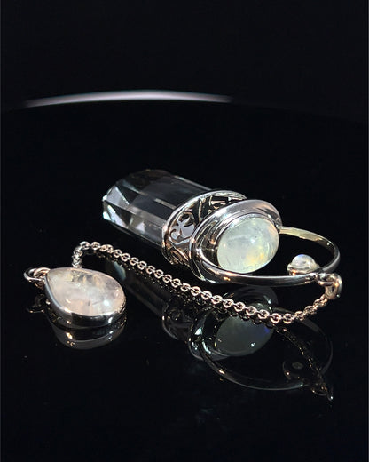 Straight 12 facet Crystal Point w/ Rainbow Moonstone Cabachons Accents and Finger Loop in Fancy .925 Silver Setting w/ Fancy Cutwork Design as a Pendulum