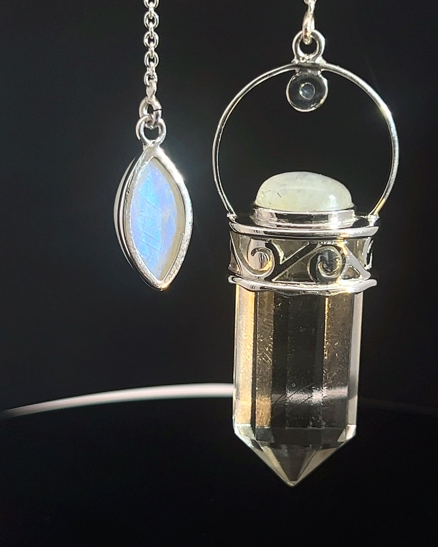 Straight 12 facet Crystal Point w/ Rainbow Moonstone Cabachons Accents and Finger Loop in Fancy .925 Silver Setting w/ Fancy Cutwork Design as a Pendulum