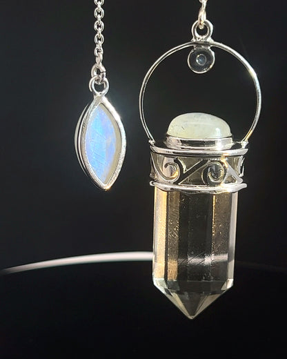 Straight 12 facet Crystal Point w/ Rainbow Moonstone Cabachons Accents and Finger Loop in Fancy .925 Silver Setting w/ Fancy Cutwork Design as a Pendulum