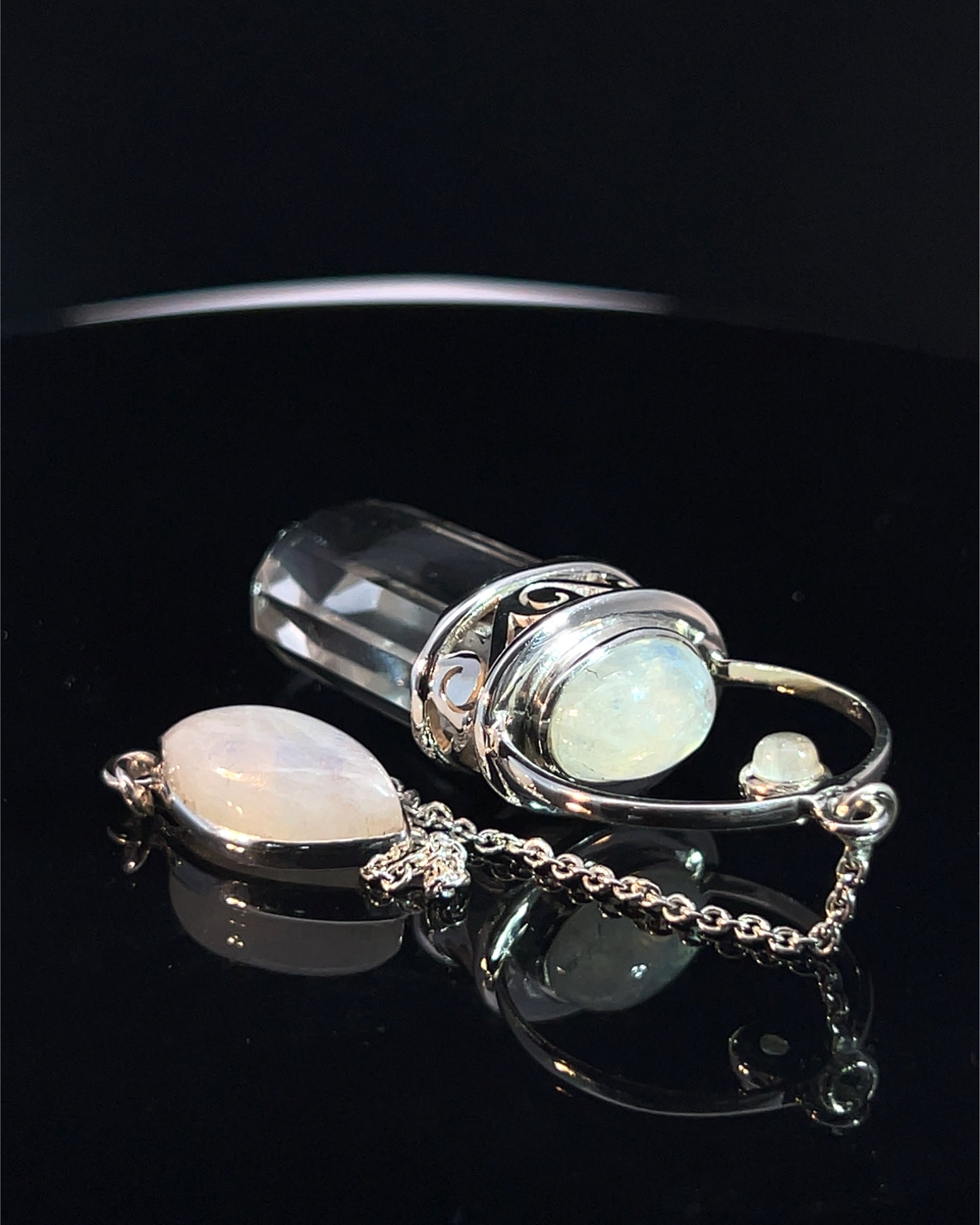 Straight 12 facet Crystal Point w/ Rainbow Moonstone Cabachons Accents and Finger Loop in Fancy .925 Silver Setting w/ Fancy Cutwork Design as a Pendulum
