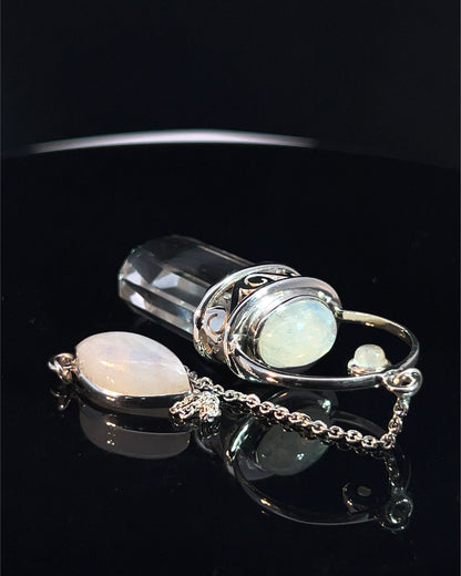 Straight 12 facet Crystal Point w/ Rainbow Moonstone Cabachons Accents and Finger Loop in Fancy .925 Silver Setting w/ Fancy Cutwork Design as a Pendulum