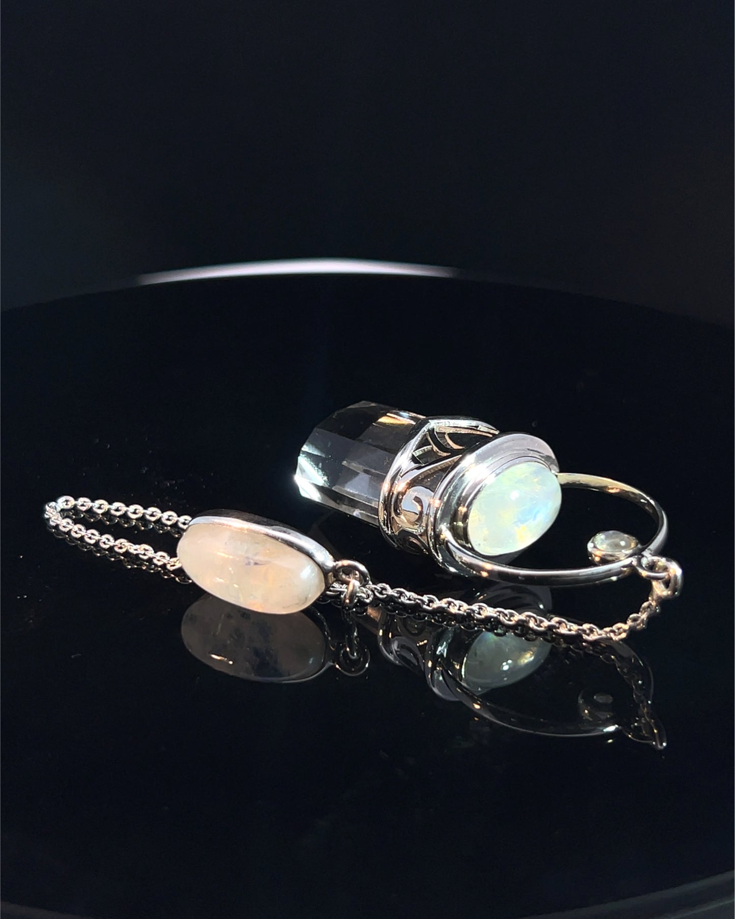 Straight 12 facet Crystal Point w/ Rainbow Moonstone Cabachons Accents and Finger Loop in Fancy .925 Silver Setting w/ Fancy Cutwork Design as a Pendulum