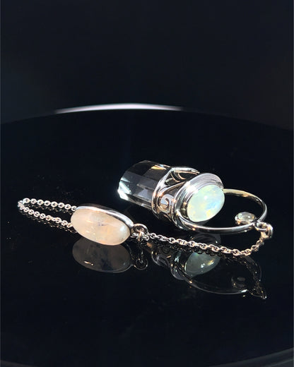 Straight 12 facet Crystal Point w/ Rainbow Moonstone Cabachons Accents and Finger Loop in Fancy .925 Silver Setting w/ Fancy Cutwork Design as a Pendulum