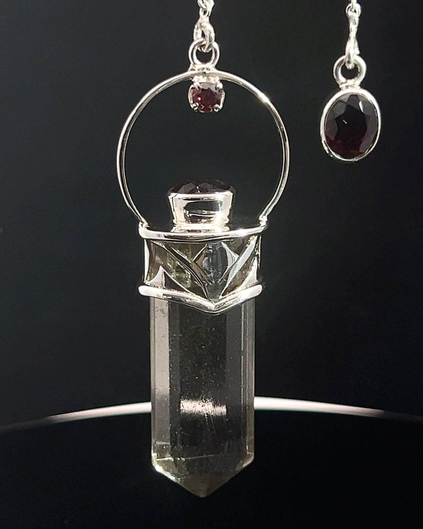 Straight 12 facet Crystal Point w/ Facetted Garnet Accents in .925 Silver Setting w/ Fancy Cutwork Design as a Pendulum