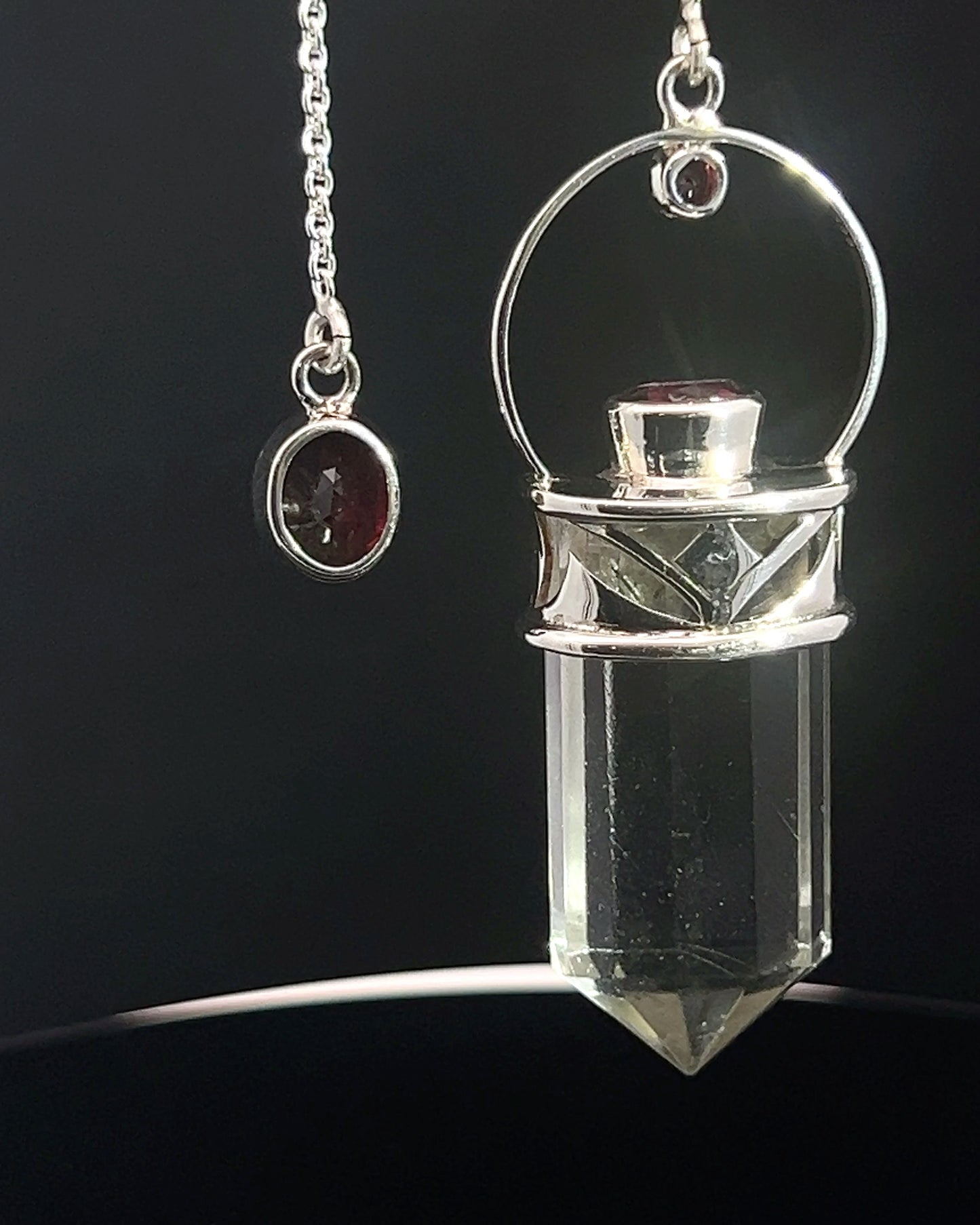 Straight 12 facet Crystal Point w/ Facetted Garnet Accents in .925 Silver Setting w/ Fancy Cutwork Design as a Pendulum