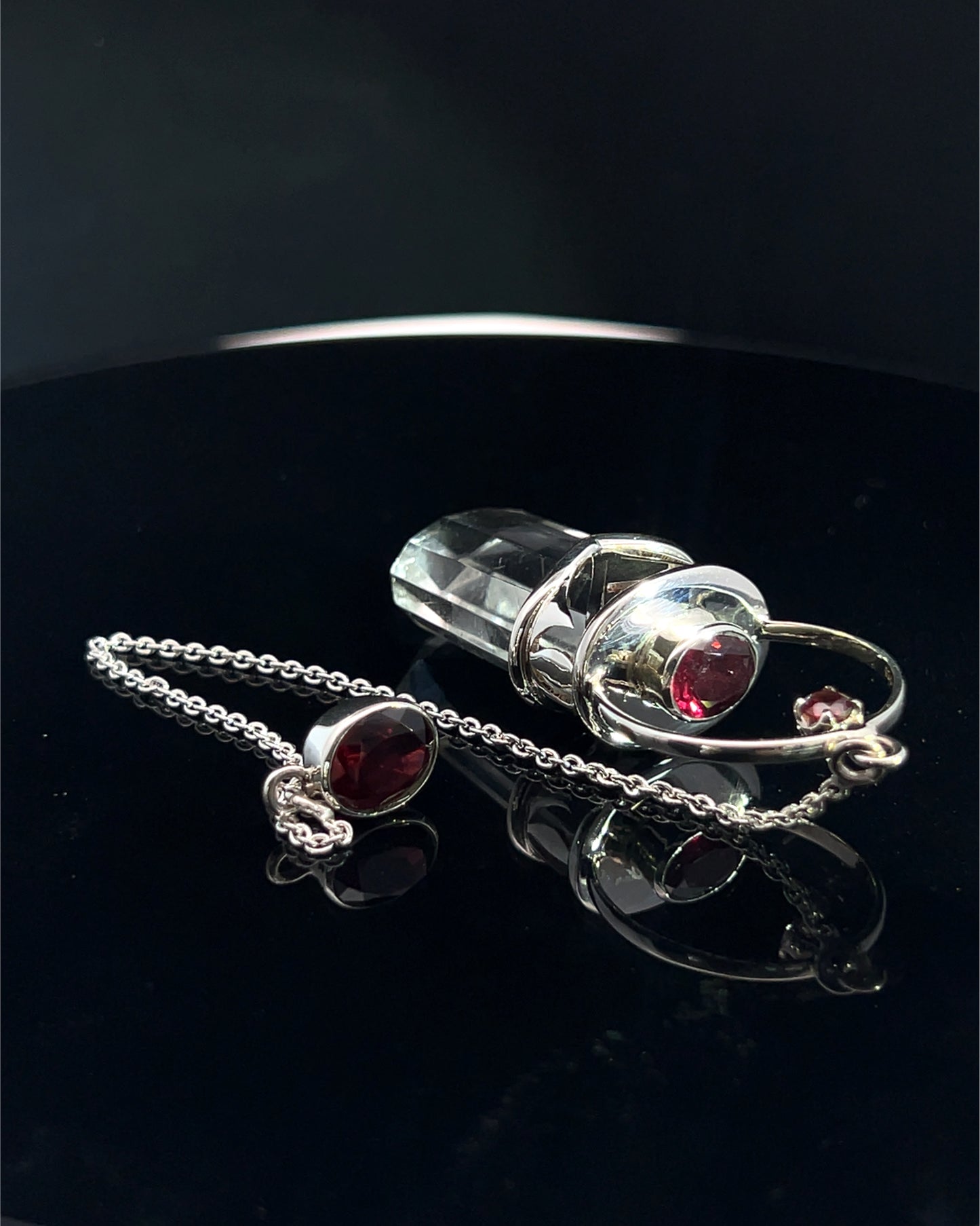Straight 12 facet Crystal Point w/ Facetted Garnet Accents in .925 Silver Setting w/ Fancy Cutwork Design as a Pendulum