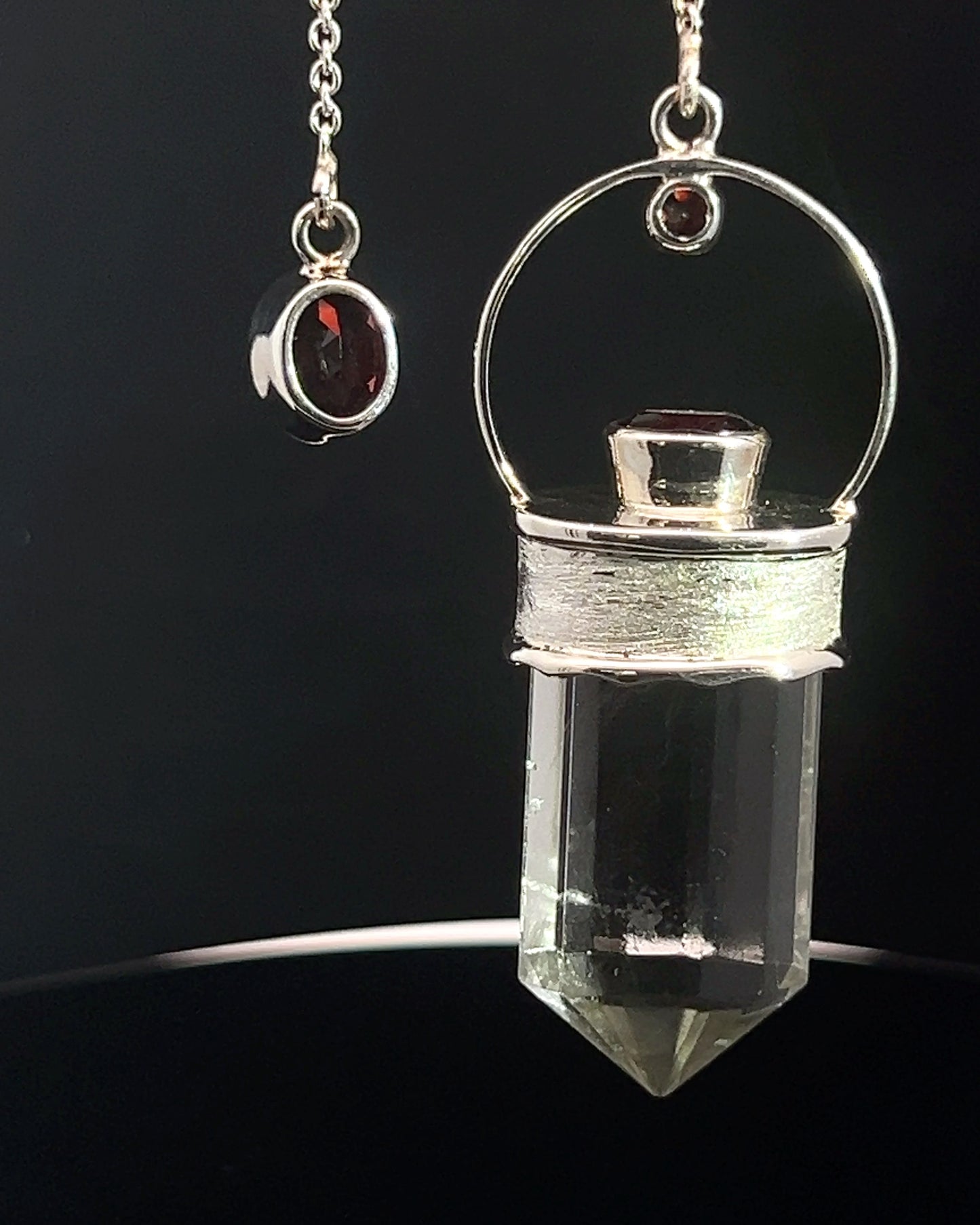 Straight 12 facet Crystal Point w/ Facetted Garnet Accents in .925 Silver Setting w/ Fancy Satin Silver Finish as a Pendulum