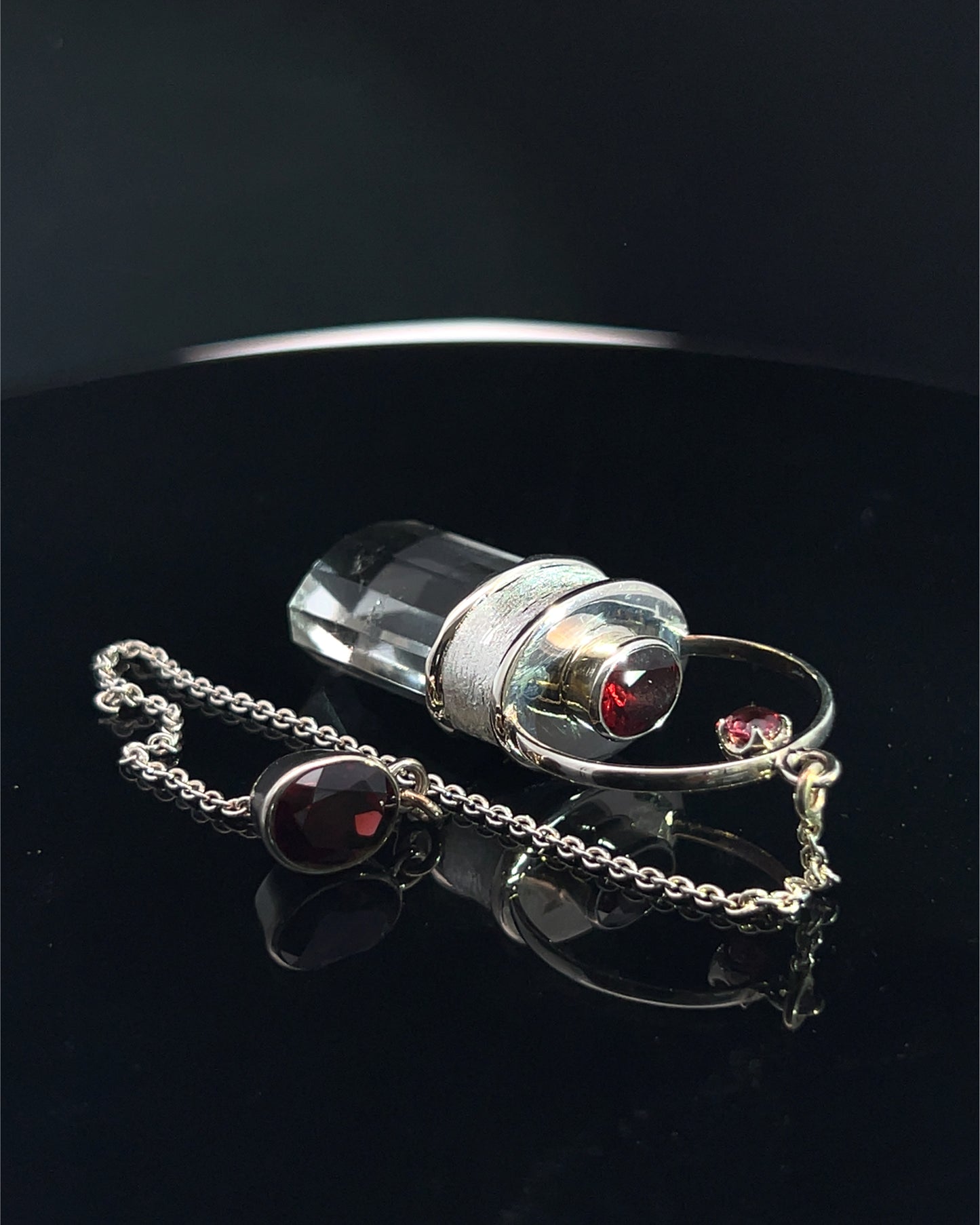 Straight 12 facet Crystal Point w/ Facetted Garnet Accents in .925 Silver Setting w/ Fancy Satin Silver Finish as a Pendulum