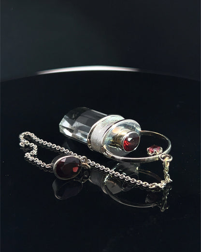 Straight 12 facet Crystal Point w/ Facetted Garnet Accents in .925 Silver Setting w/ Fancy Satin Silver Finish as a Pendulum