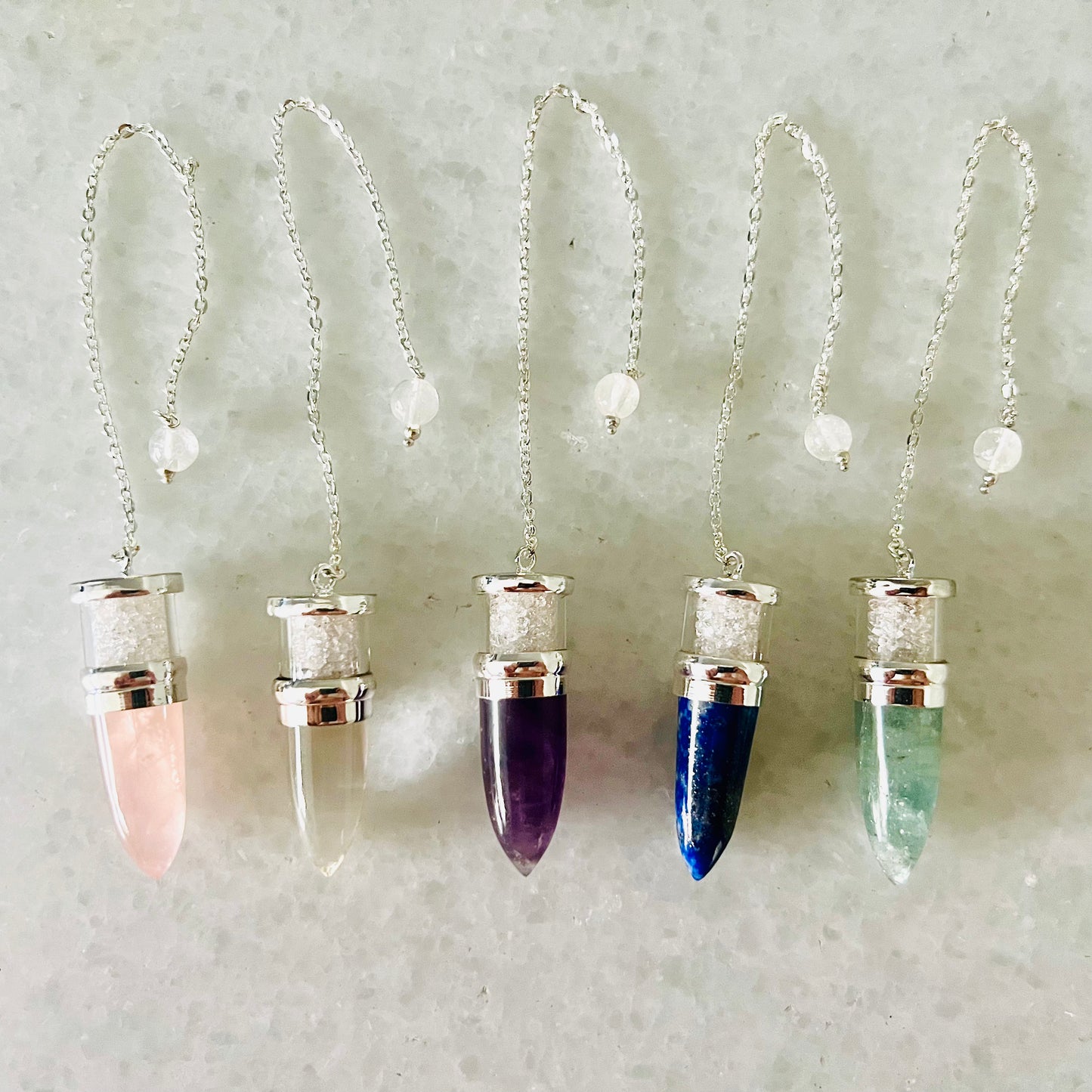 Pendules remplis de pierres d'Herkimer : 15 pointes de quartz, 15 pointes de quartz rose, 5 pointes d'aigue-marine, 4 pointes de lapis-lazuli et 10 pointes d'améthyste.