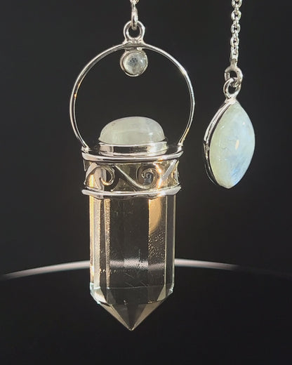 Straight 12 facet Crystal Point w/ Rainbow Moonstone Cabachons Accents and Finger Loop in Fancy .925 Silver Setting w/ Fancy Cutwork Design as a Pendulum